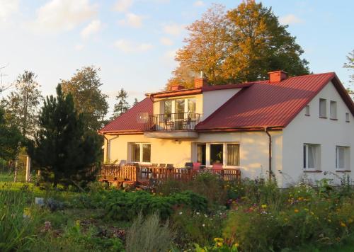a white house with a red roof at Agrocamp in Pawłówka
