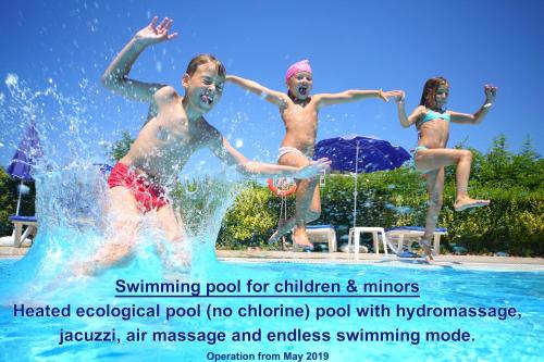 a group of people jumping in a swimming pool at Galazio Asteri 1 Green, Luxury & Eco in Loutrópolis Thermís