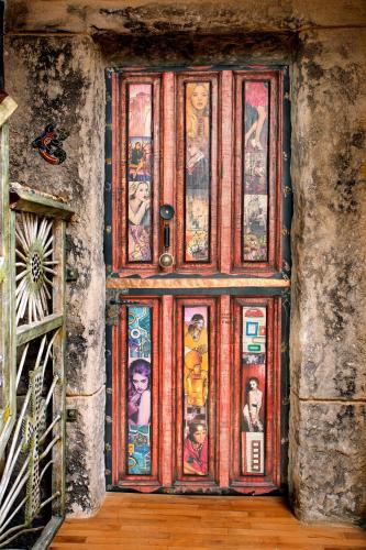 a wooden door with paintings on it in a building at Anahuaska Art - Suites Temáticas in Panzares