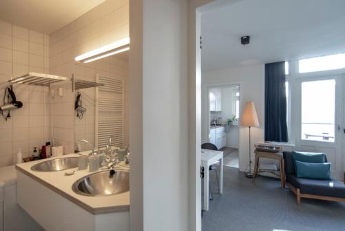 a bathroom with a large sink and a kitchen at Here's Lucy in Amsterdam