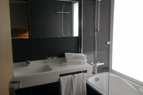 a bathroom with a sink and a shower and a mirror at Atenea Port Barcelona Mataró in Mataró