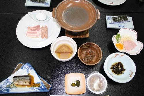 a table with plates of food on it at Hotel Grand Toya in Lake Toya