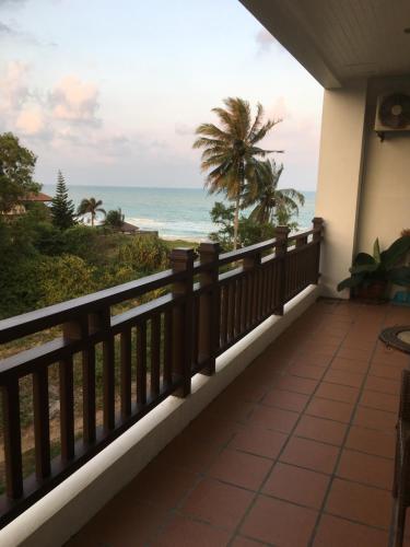 a balcony with a view of the ocean at Khanom Beach Residence Monthly Rental Condo in Khanom
