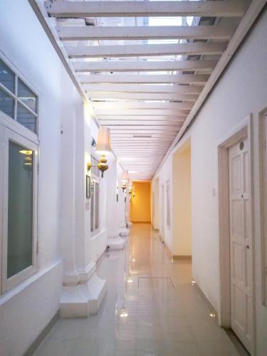 a hallway in a building with a ceiling at Chulia Heritage Hotel in George Town