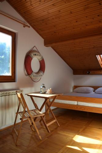 a bedroom with a bed and a table and a chair at Apartments Tonka Grebaštica in Grebaštica