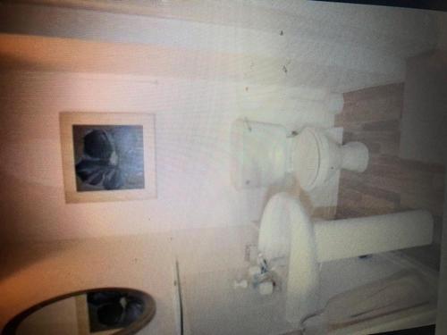 a bathroom with a toilet and a sink at Beach Front Apt Portballintrae , Bushmills close to Royal Portrush Golf Club in Portballintrae