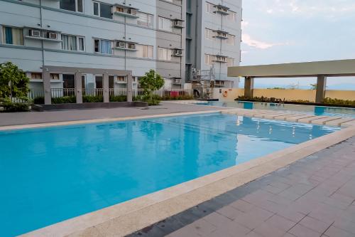 a swimming pool in front of a building at Avida Towers Davao in Davao City