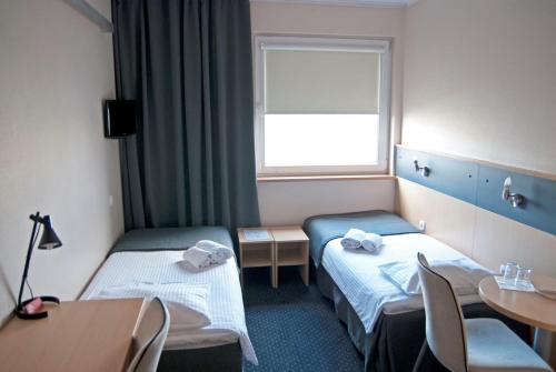 Posteľ alebo postele v izbe v ubytovaní Economy Silesian Hotel