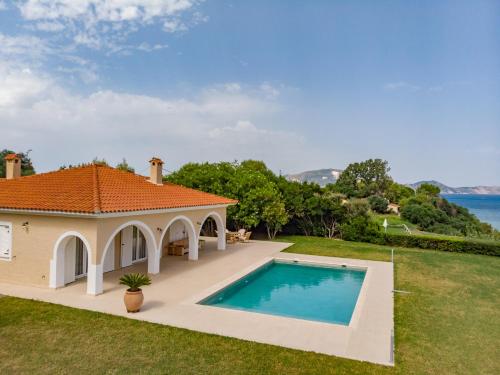 a house with a swimming pool in the yard at Zante Vista Villas in Lithakia