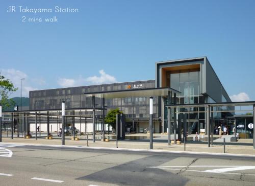 a large glass building with a street in front of it at K's House Takayama Oasis [2nd K's Hostel] in Takayama