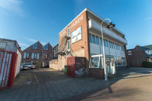 a brick building with a fire escape on the side of it at Hotel Faber in Zandvoort