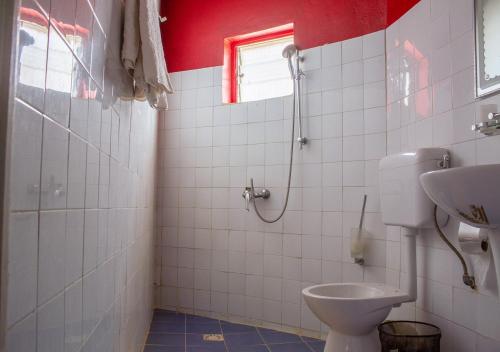 a bathroom with a toilet and a sink at Melia Hotel in Saly Portudal