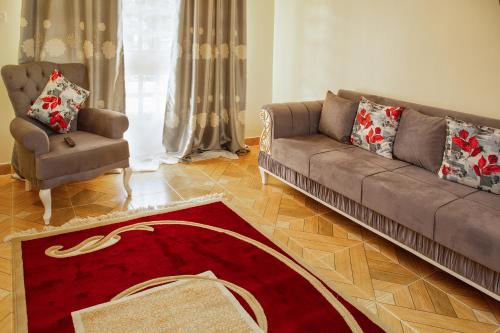 a living room with a couch and a chair at Ashville Homes Meru in Meru