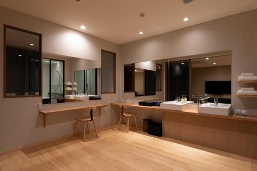 a bathroom with two sinks and two mirrors at 宮島離れの宿 IBUKU -Miyajima Hanare no Yado IBUKU- in Miyajima