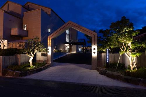 a house with a lit up driveway at night at Miyajima Hanare no Yado IBUKU in Miyajima