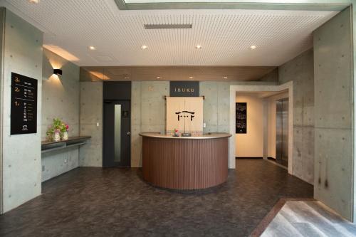 a lobby with a bar in the middle of a building at 宮島離れの宿 IBUKU -Miyajima Hanare no Yado IBUKU- in Miyajima
