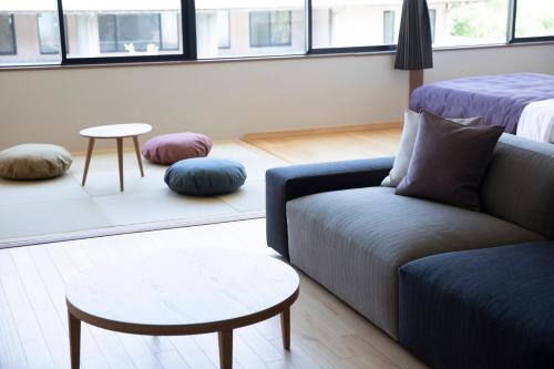 a living room with a couch and a table at 宮島離れの宿 IBUKU -Miyajima Hanare no Yado IBUKU- in Miyajima