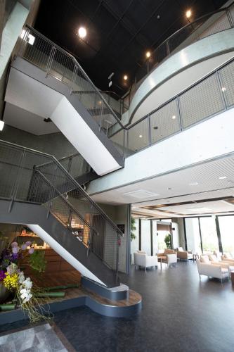 a lobby with a spiral staircase in a building at 宮島離れの宿 IBUKU -Miyajima Hanare no Yado IBUKU- in Miyajima