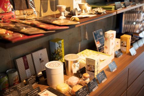 a display of food on a shelf in a store at 宮島離れの宿 IBUKU -Miyajima Hanare no Yado IBUKU- in Miyajima