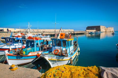 a group of boats docked in a harbor at Metropole Urban Hotel in Heraklio Town