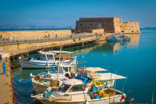 a group of boats are docked at a dock at Metropole Urban Hotel in Heraklio Town