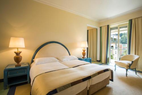Postel nebo postele na pokoji v ubytování Grand Hotel Villa Castagnola
