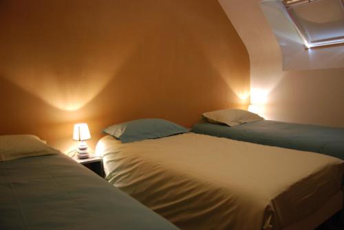 two beds sitting next to each other in a room at La Ferme du Chauchix in Lamballe