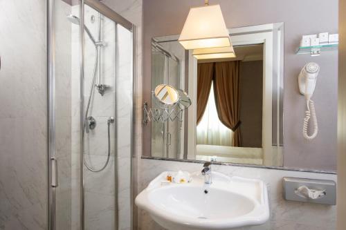 a bathroom with a sink and a shower at Hotel Rapallo in Florence