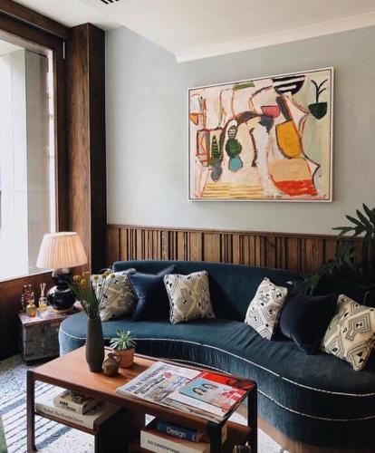 a living room with a blue couch and a table at Redchurch Townhouse in London