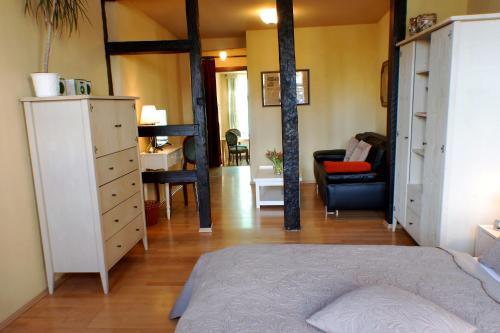a bedroom with a bed and a living room at Ferienwohnungen Stobenstraße in Quedlinburg