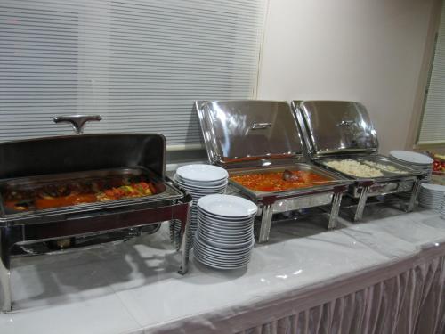 a buffet line with trays of food and plates of food at Anya Suit Otel in Denizli