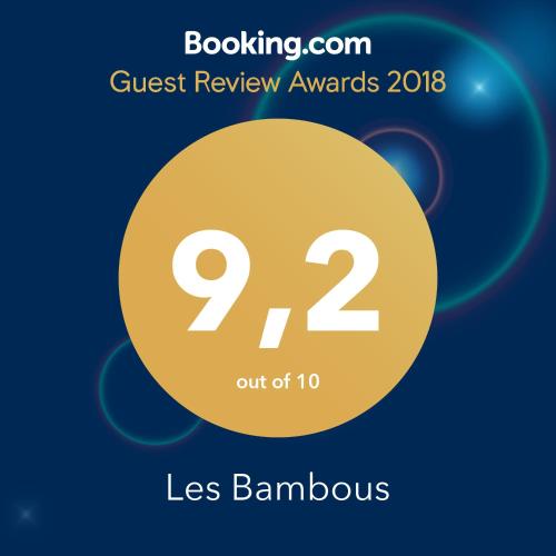 a sign that says guest review awards with a yellow circle at Les Bambous in Petite Île