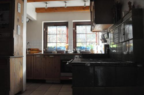a kitchen with a sink and a stove top oven at Birchy Hills in Sitno
