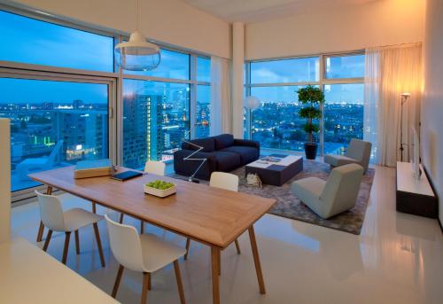 a living room with a table and chairs and a large window at Urban Residences Rotterdam in Rotterdam