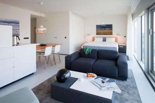 a bedroom and a living room with a bed and a couch at Urban Residences Rotterdam in Rotterdam