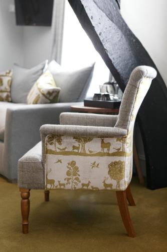 a living room with a chair and a couch at The Rose and Crown in Warwick