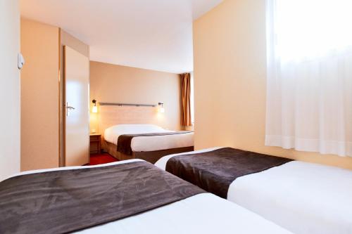 Кровать или кровати в номере Kyriad Beauvais Sud