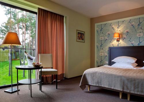 מיטה או מיטות בחדר ב-Margis Hotel & SPA