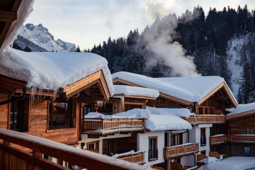a group of buildings with snow covered roofs at Kaiserlodge in Scheffau am Wilden Kaiser