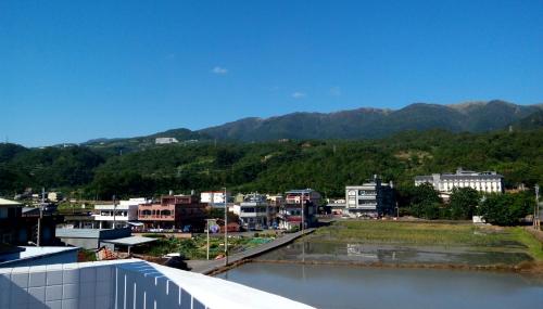 a view of a city with mountains in the background at 5963 Turn Right B&B in Jiaoxi
