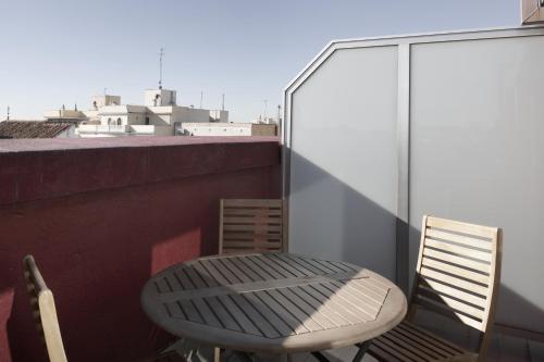 a chair and a table on a balcony at Petit Palace Plaza Mayor in Madrid