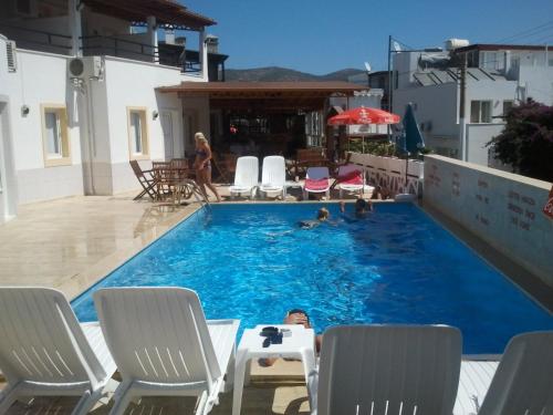 a group of people in a swimming pool at Cam Hotel in Gümbet