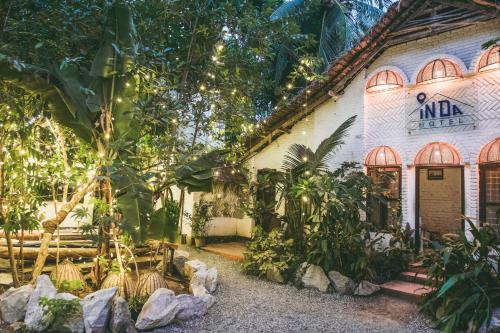 a building with a bunch of plants in front of it at InDa hotel in Varkala