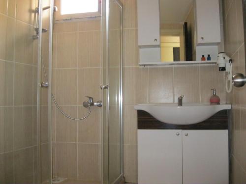 a bathroom with a sink and a shower at Anya Suit Otel in Denizli