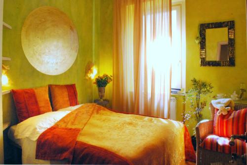 a bedroom with a bed and a window at Locanda di Mirandolina in Tuscania