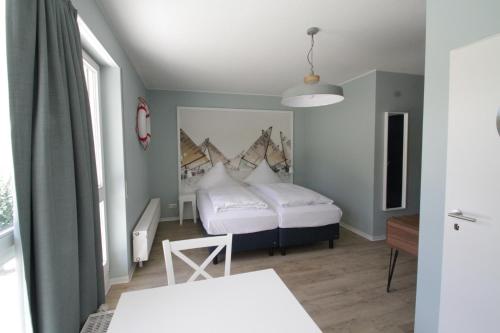 Ένα ή περισσότερα κρεβάτια σε δωμάτιο στο Havelhotel