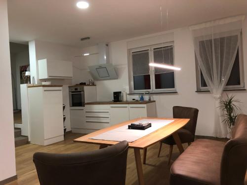 a kitchen with a wooden table in a room at eifel5star - Burgfriedstraße in Daun