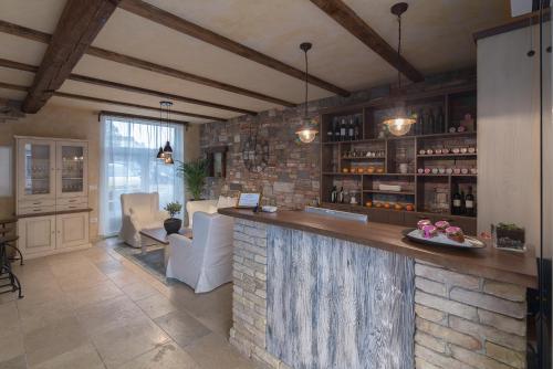 a bar in a room with a brick wall at Hotel Stara šola - Oleander Resort in Izola
