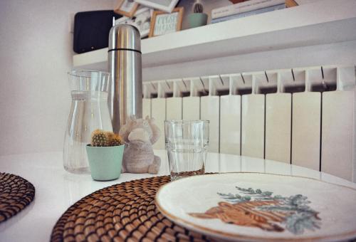 a table with a sink and a plate and glasses at Casa Mysa - Apartment in Costa di Mezzate