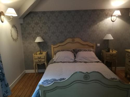 a bedroom with a large bed with two night stands at Le Dauphin in Chabeuil